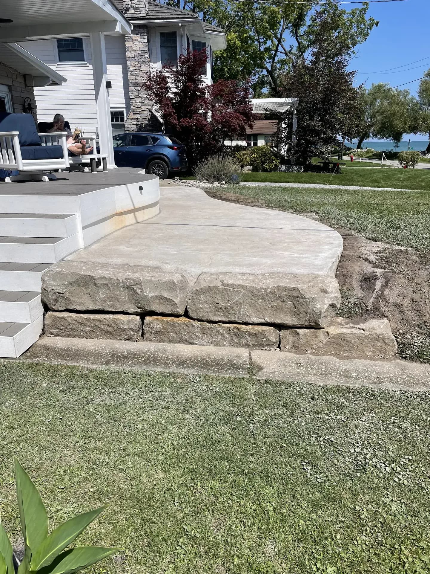 Concrete walkway with boulder wall